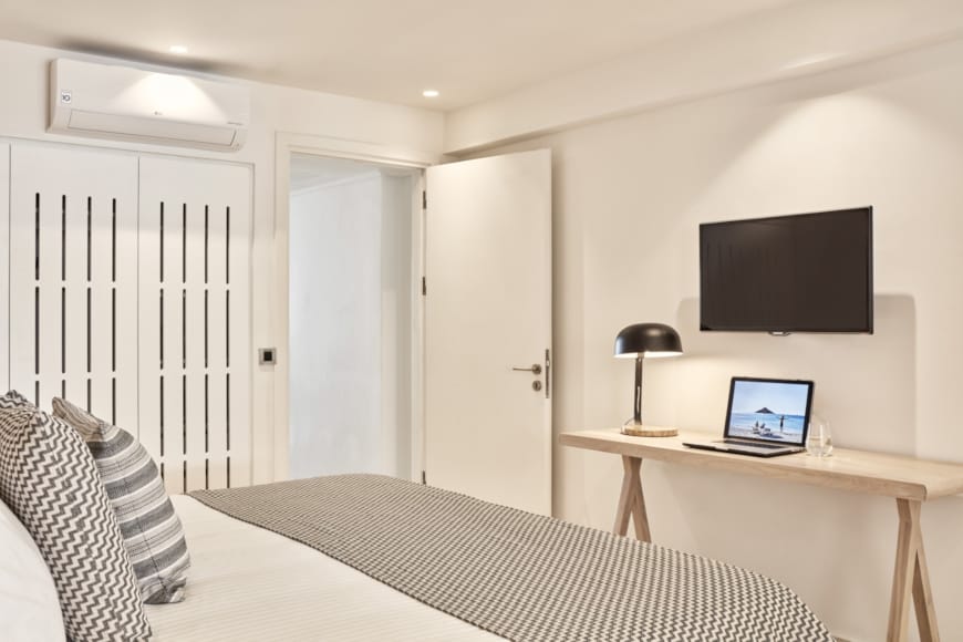 a bedroom with a tv and a bed