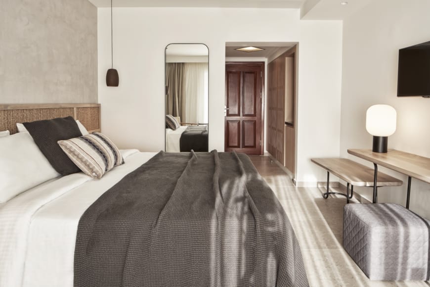 a hotel room with a bed and a desk