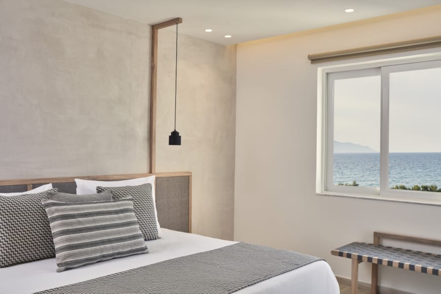 a bed with pillows and a lamp