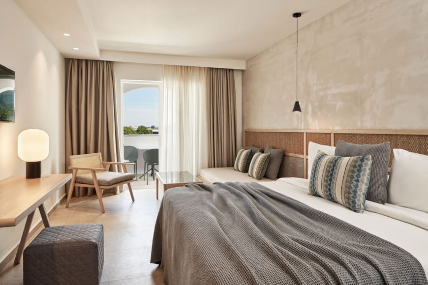 a bedroom with a bed and chairs