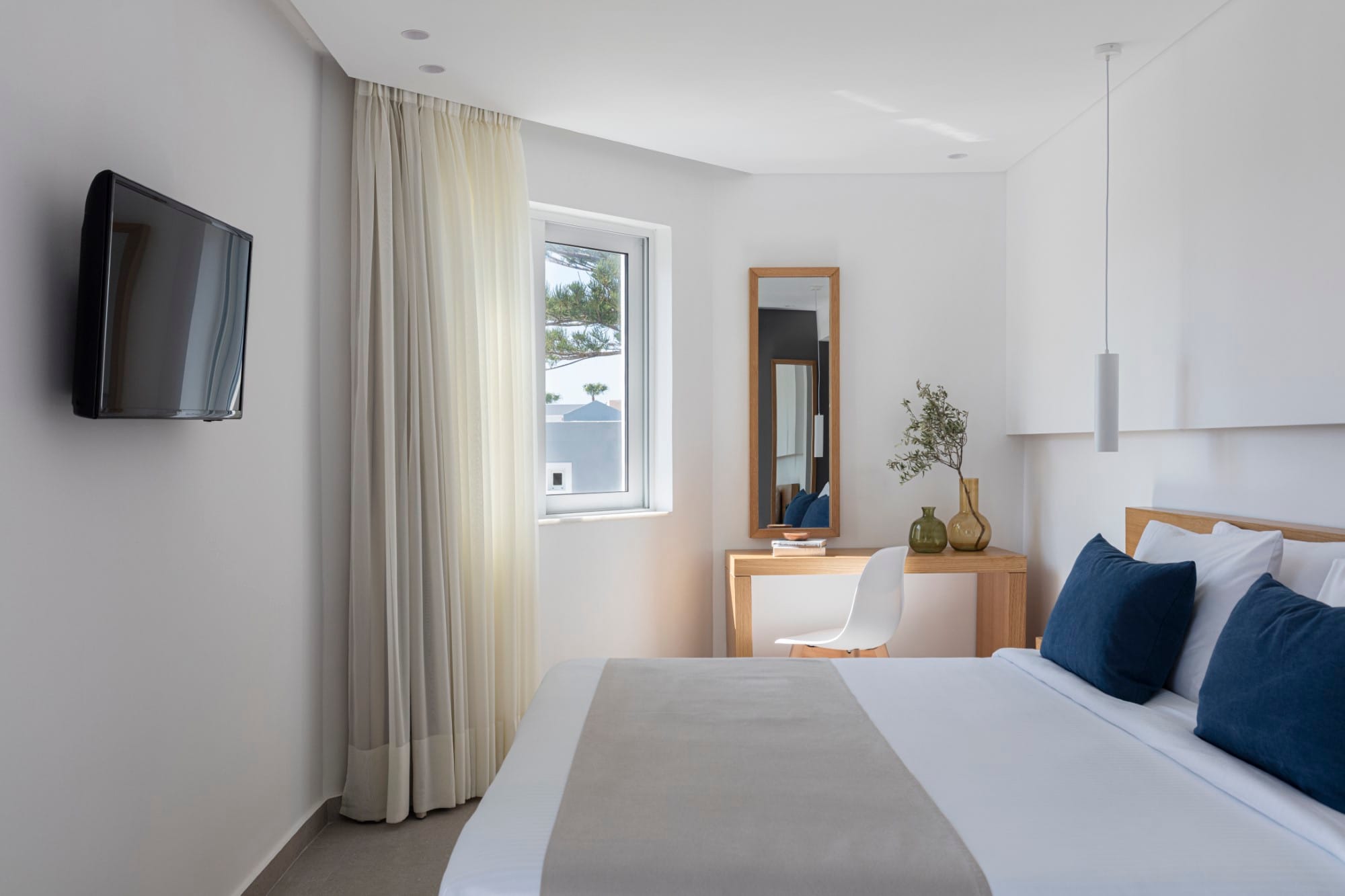 a bedroom with a bed and a tv