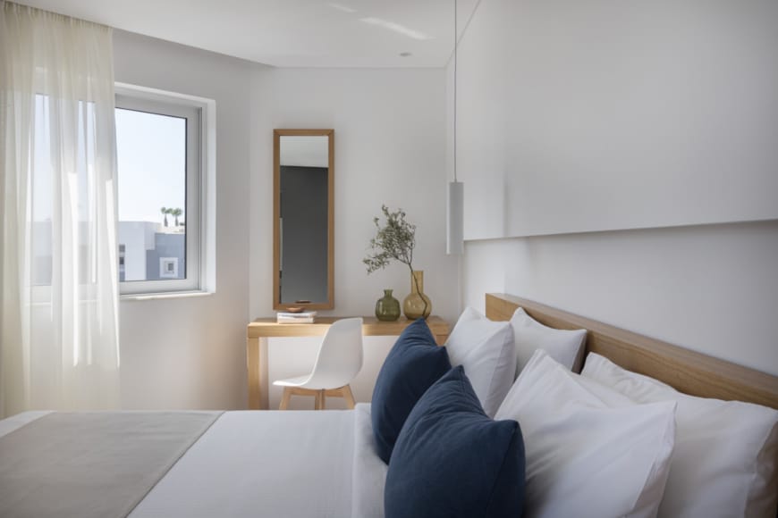 a bedroom with a bed and a table