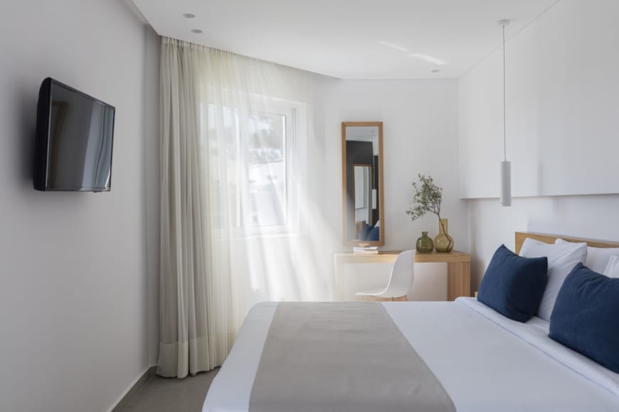 a bedroom with a bed and a tv
