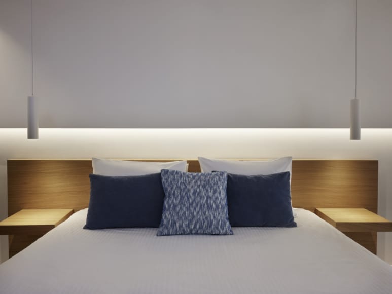 a bed with blue pillows