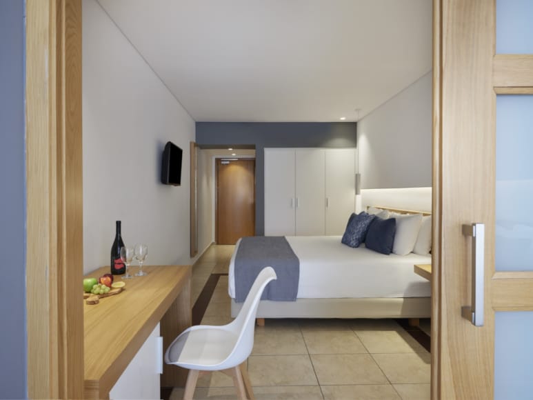 a bedroom with a bed and a chair