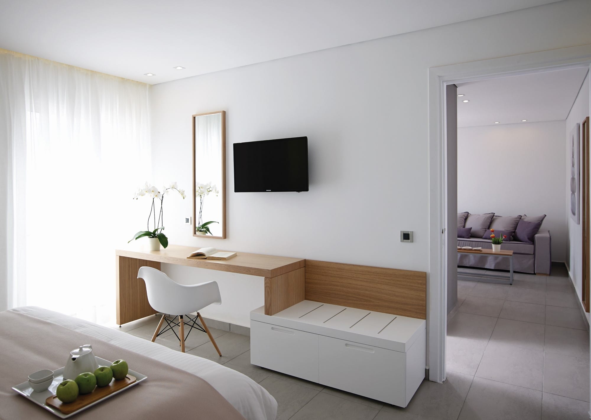 a living room with a tv and couches