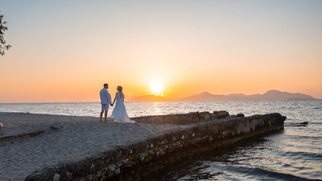 a man and woman walking on a beach