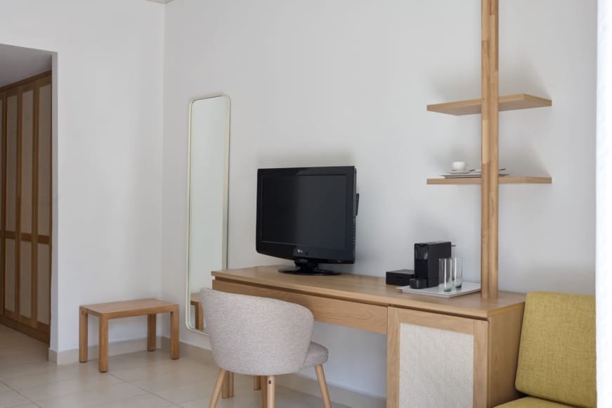 a desk with a tv and chairs