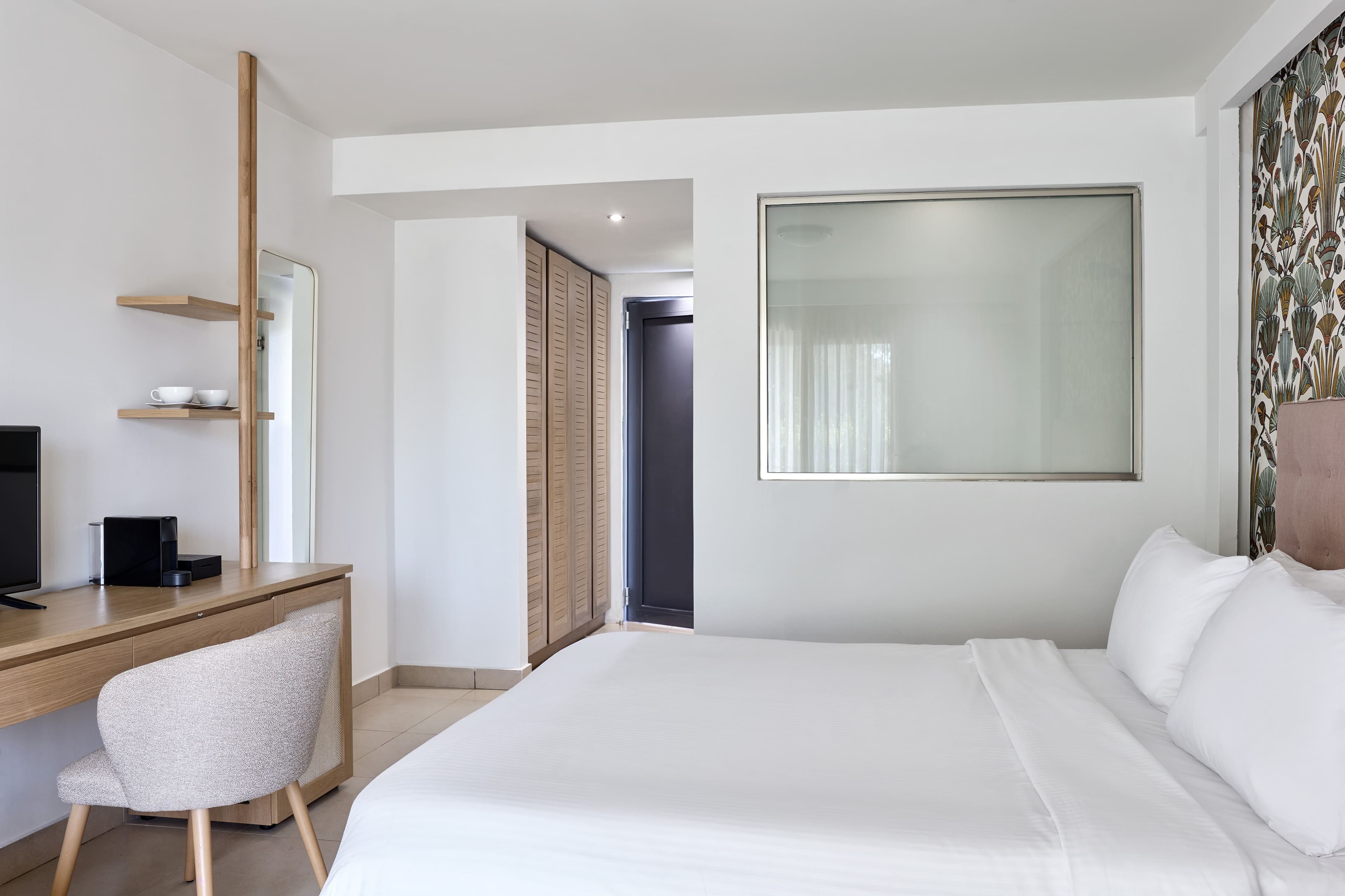 a bedroom with a bed and a desk