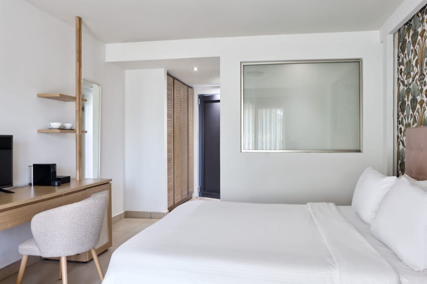 a bedroom with a bed and a desk