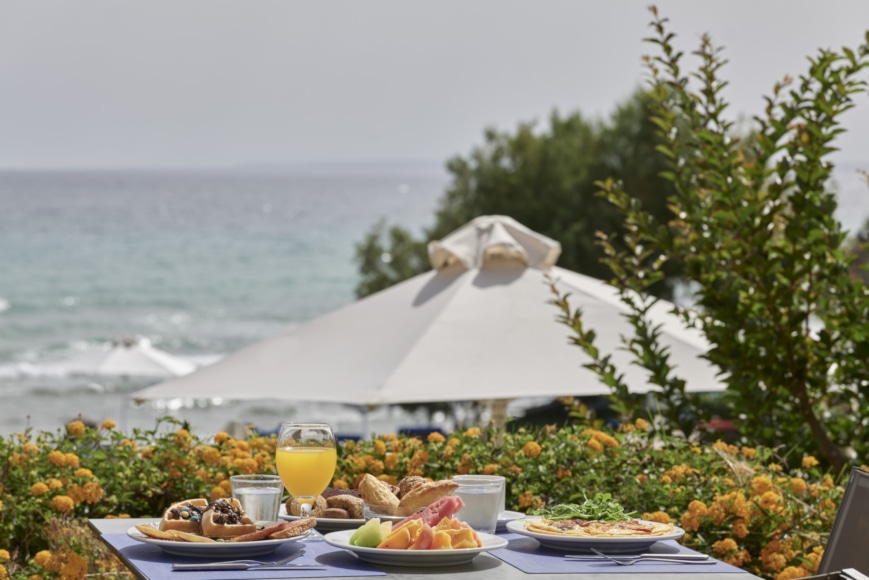 a table with food and drinks on it by a body of water