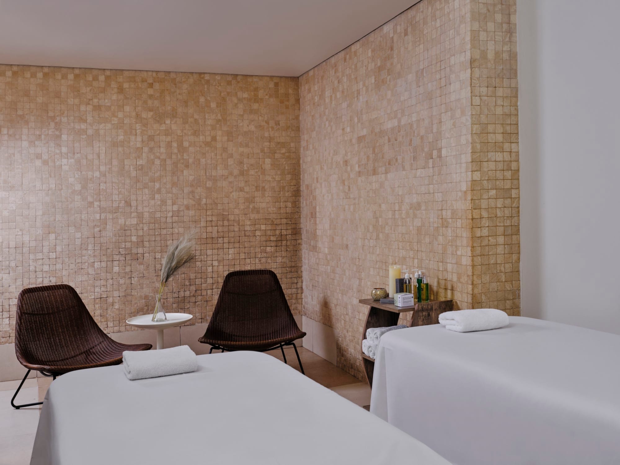 a hotel room with a bed and a chair