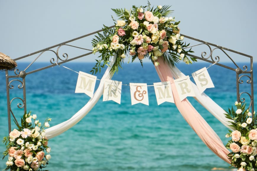 a white arch with flowers on it