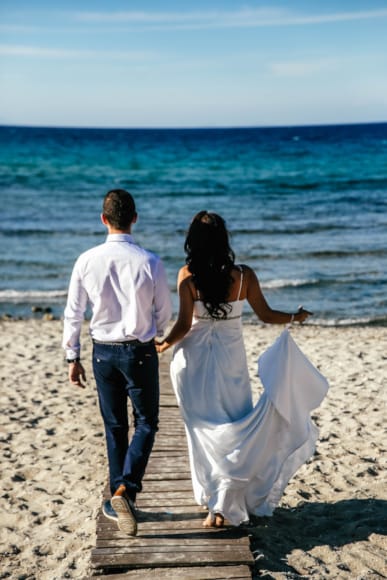 a man and woman walking on a beach