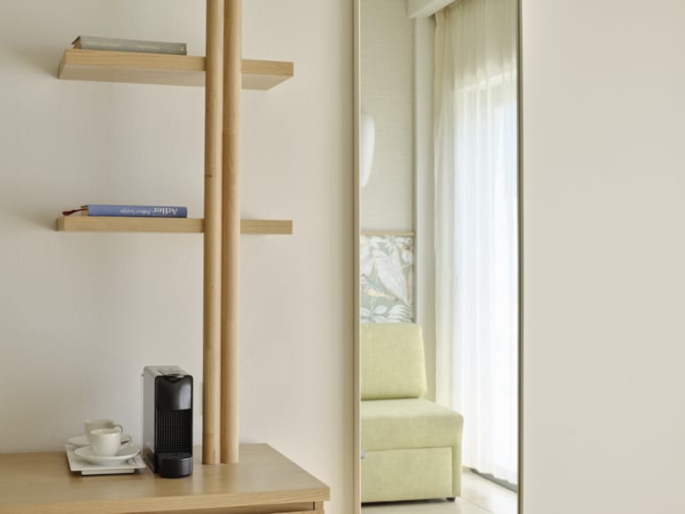a room with a shelf and a chair