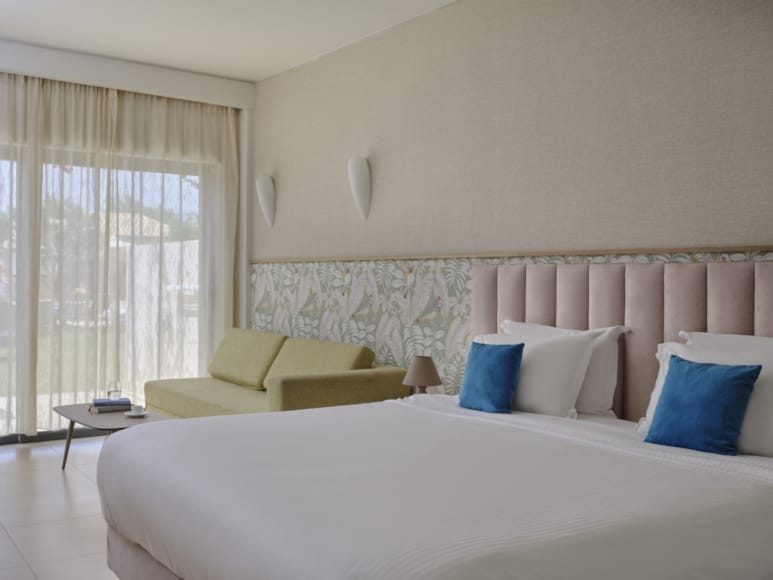 a bed with a white bed and yellow pillows