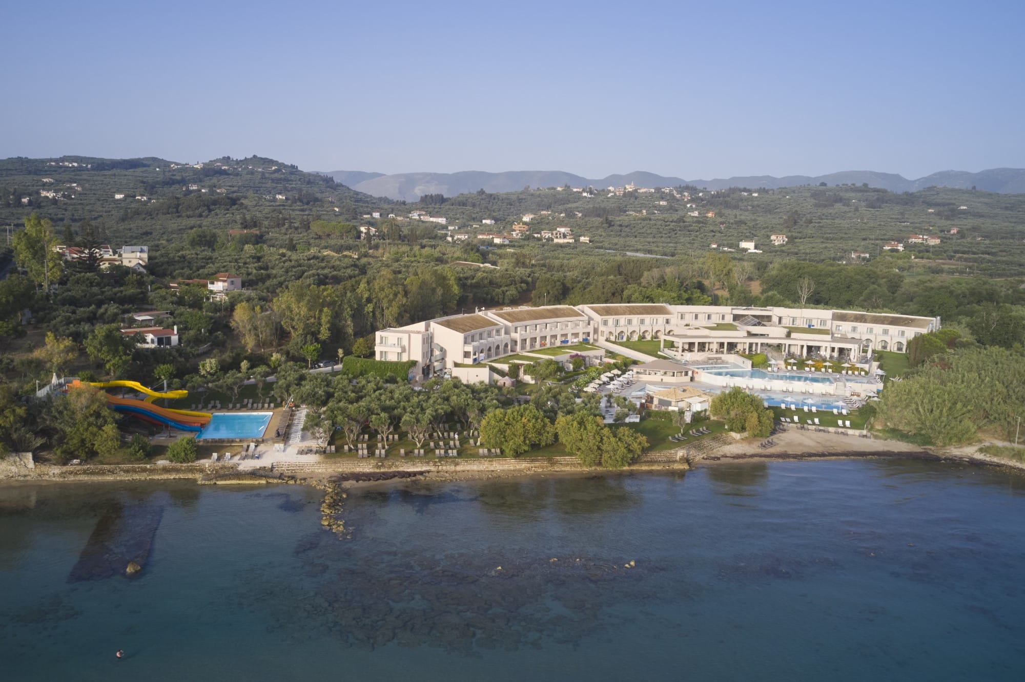 a body of water with buildings and trees around it