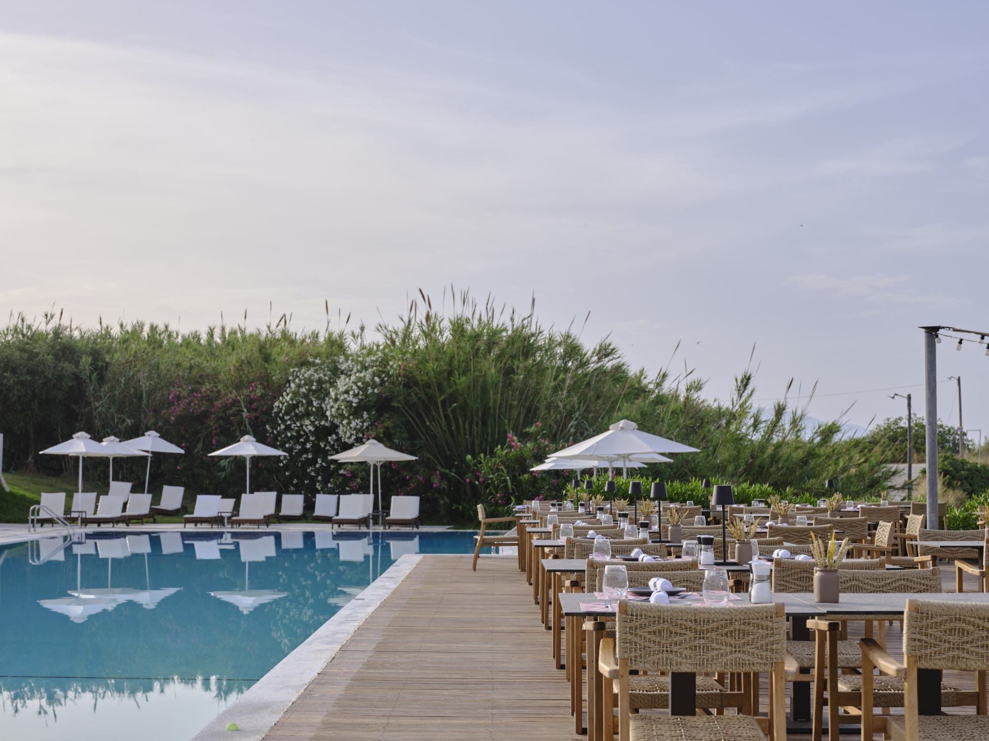 a pool with tables and chairs next to it