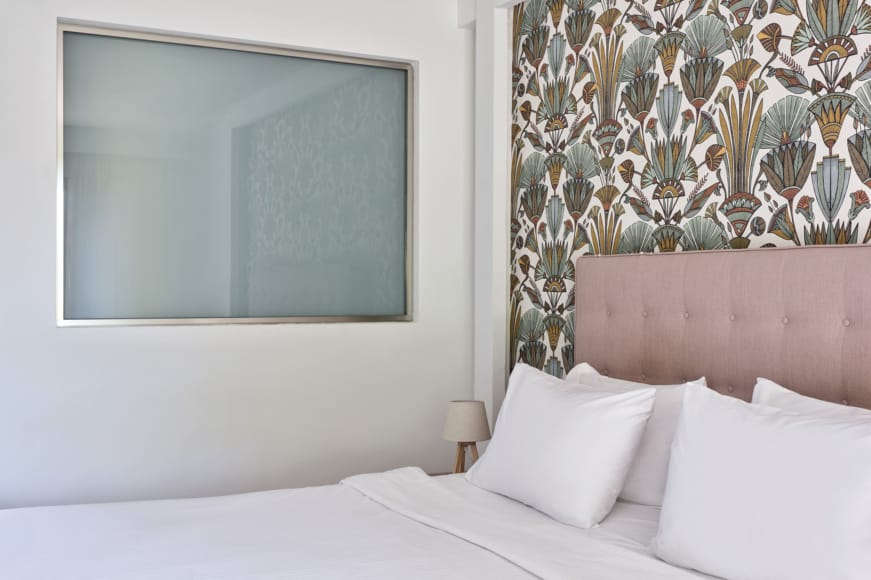 a bed with a mirror on the wall