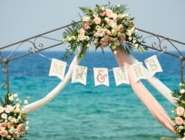 a white arch with flowers on it