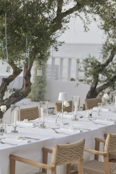 a table with glasses and candles on it