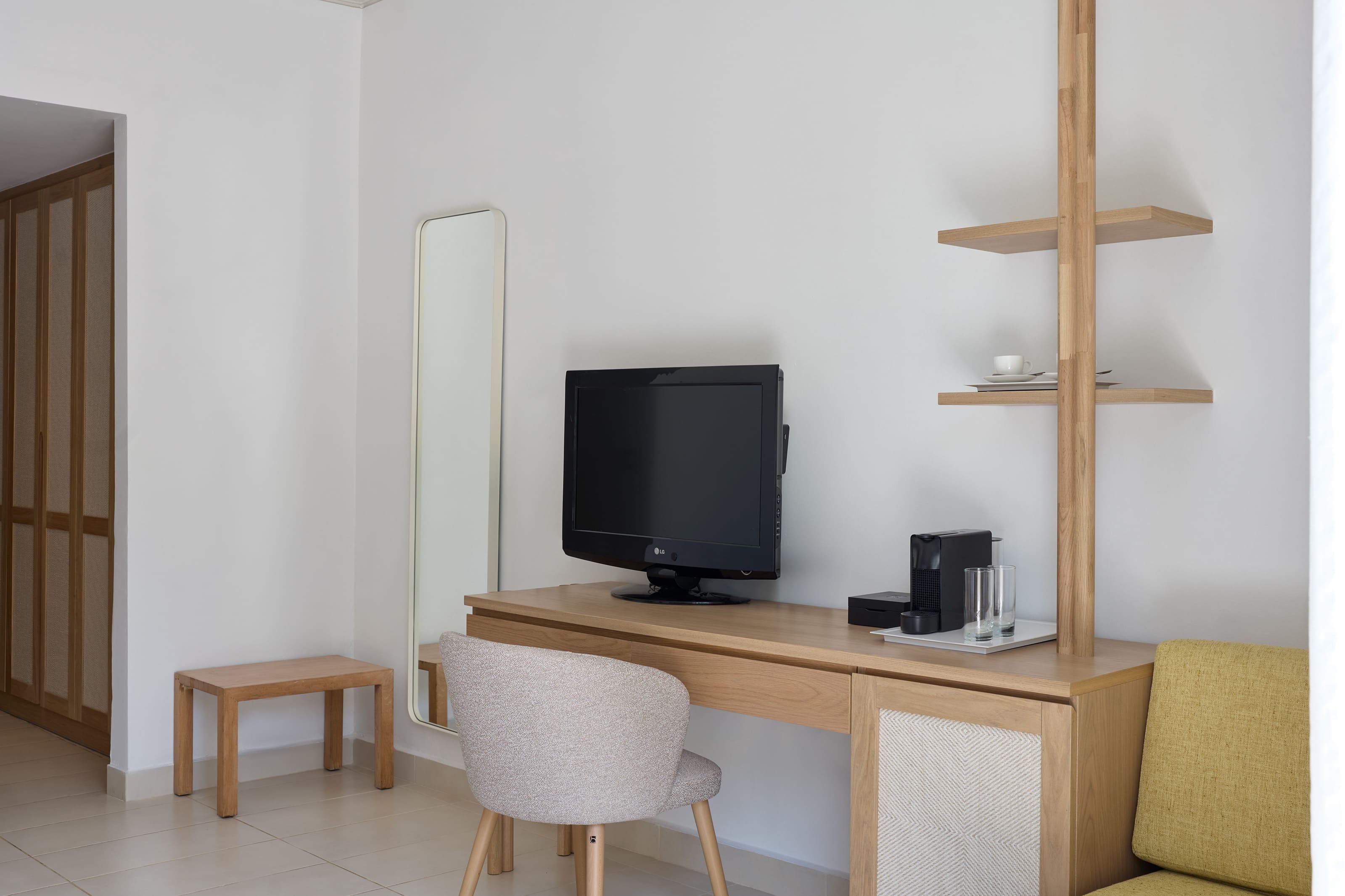 a desk with a tv and chairs