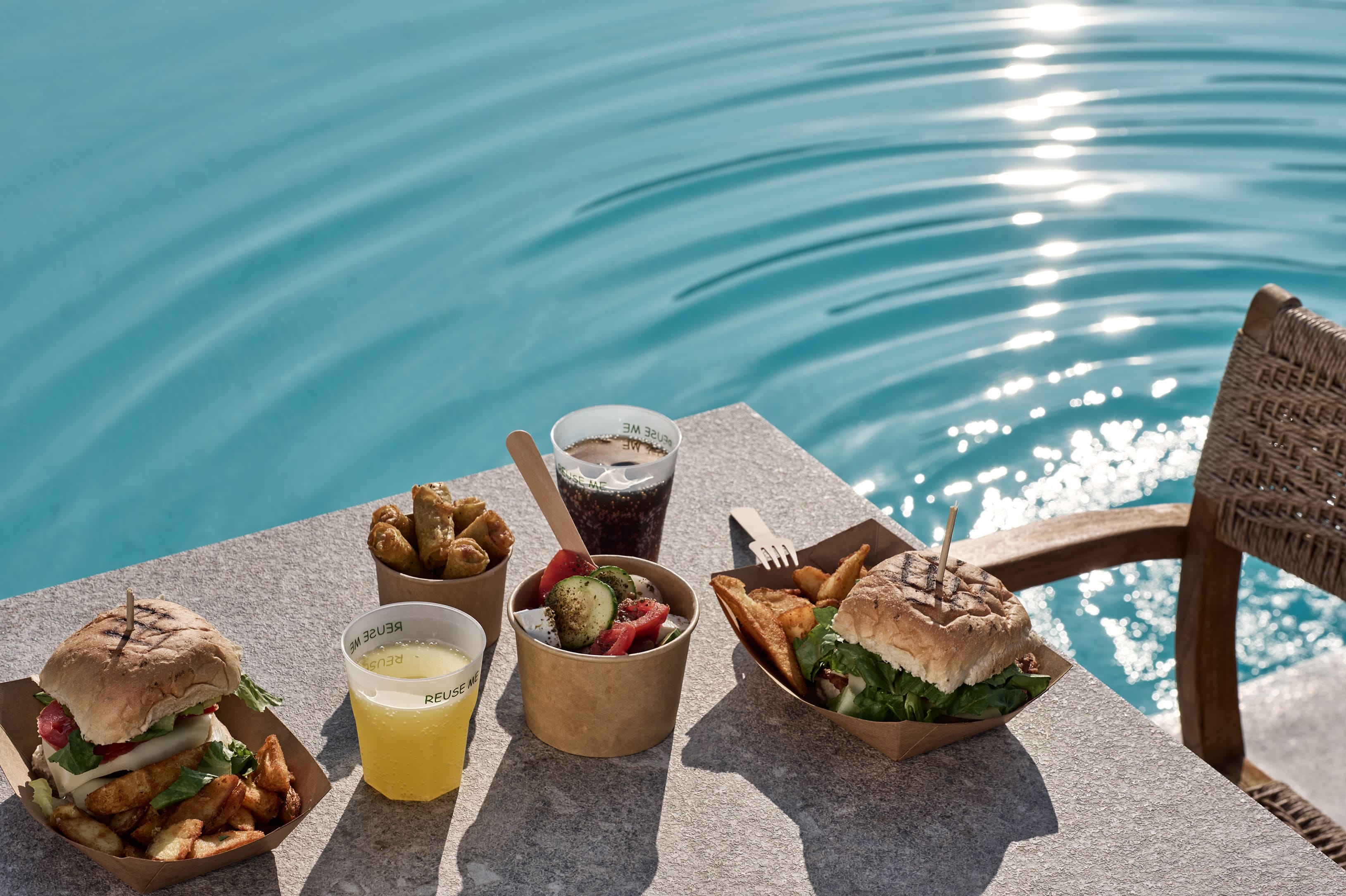 a table with food and drinks on it by a body of water