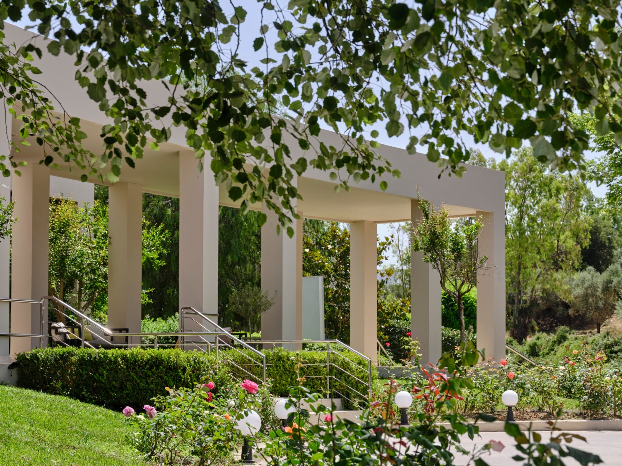 a building with columns and plants