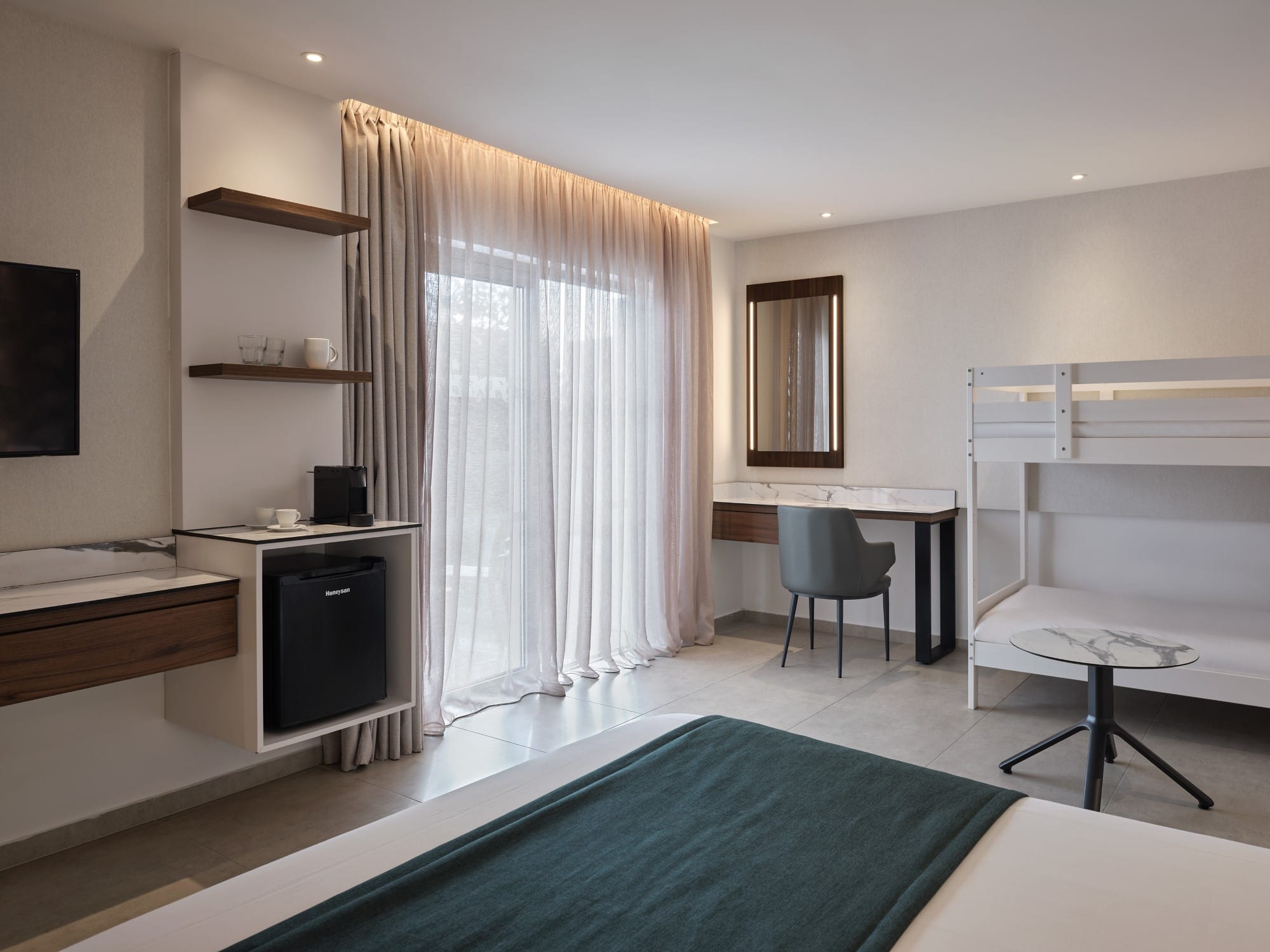 a room with a bed desk and a chair