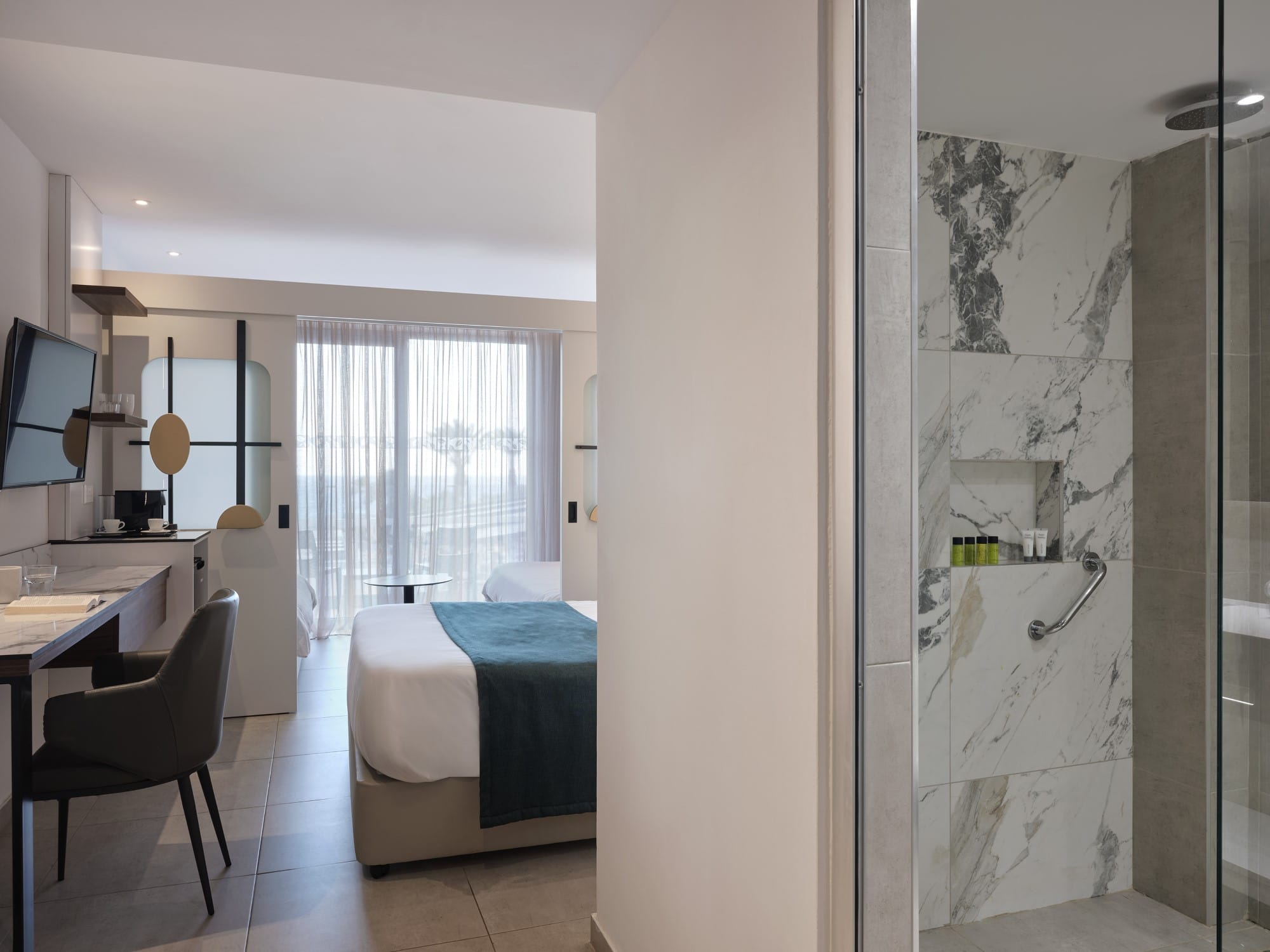 a room with a bed and a desk