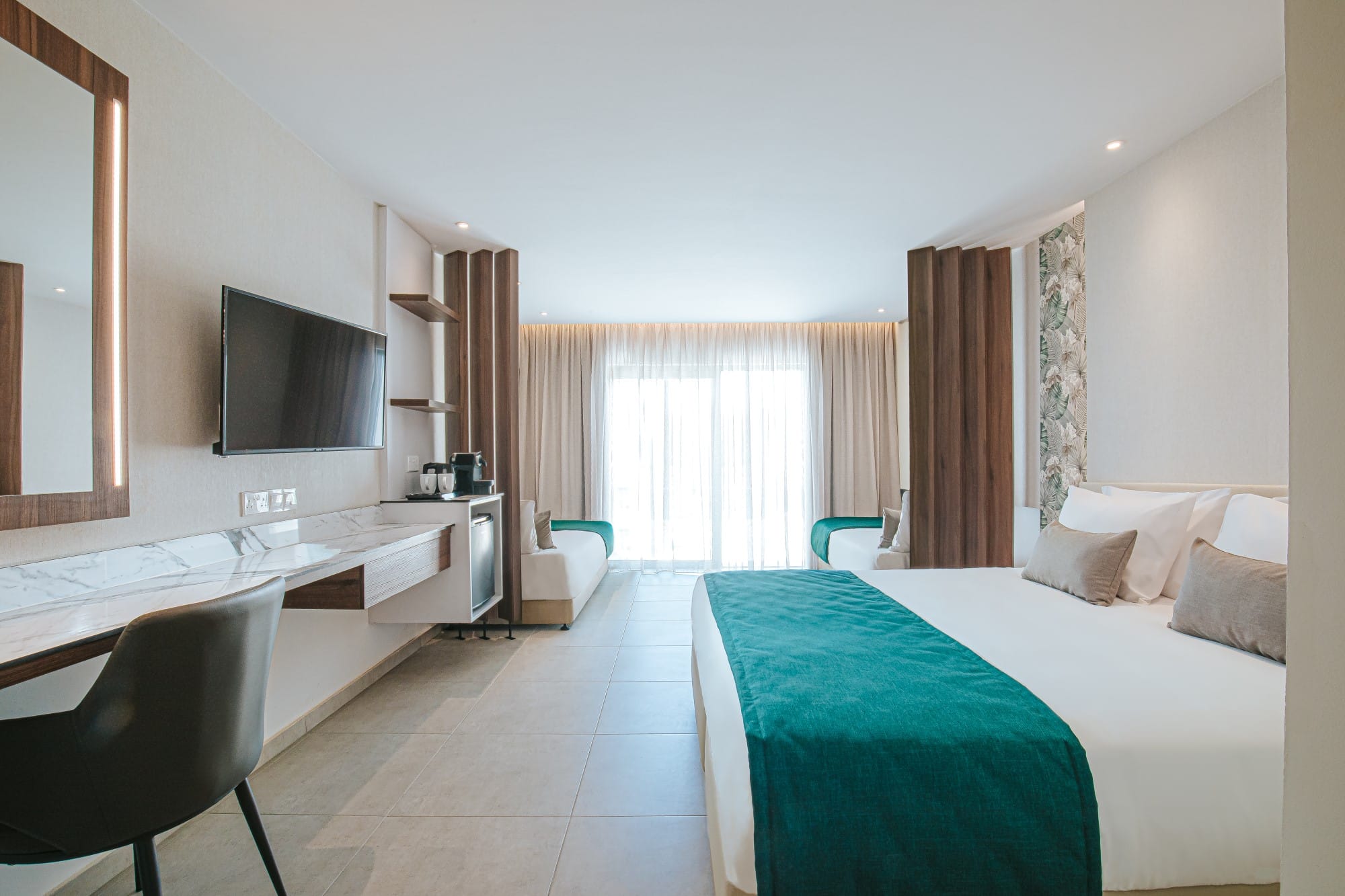 a hotel room with a bed and desk