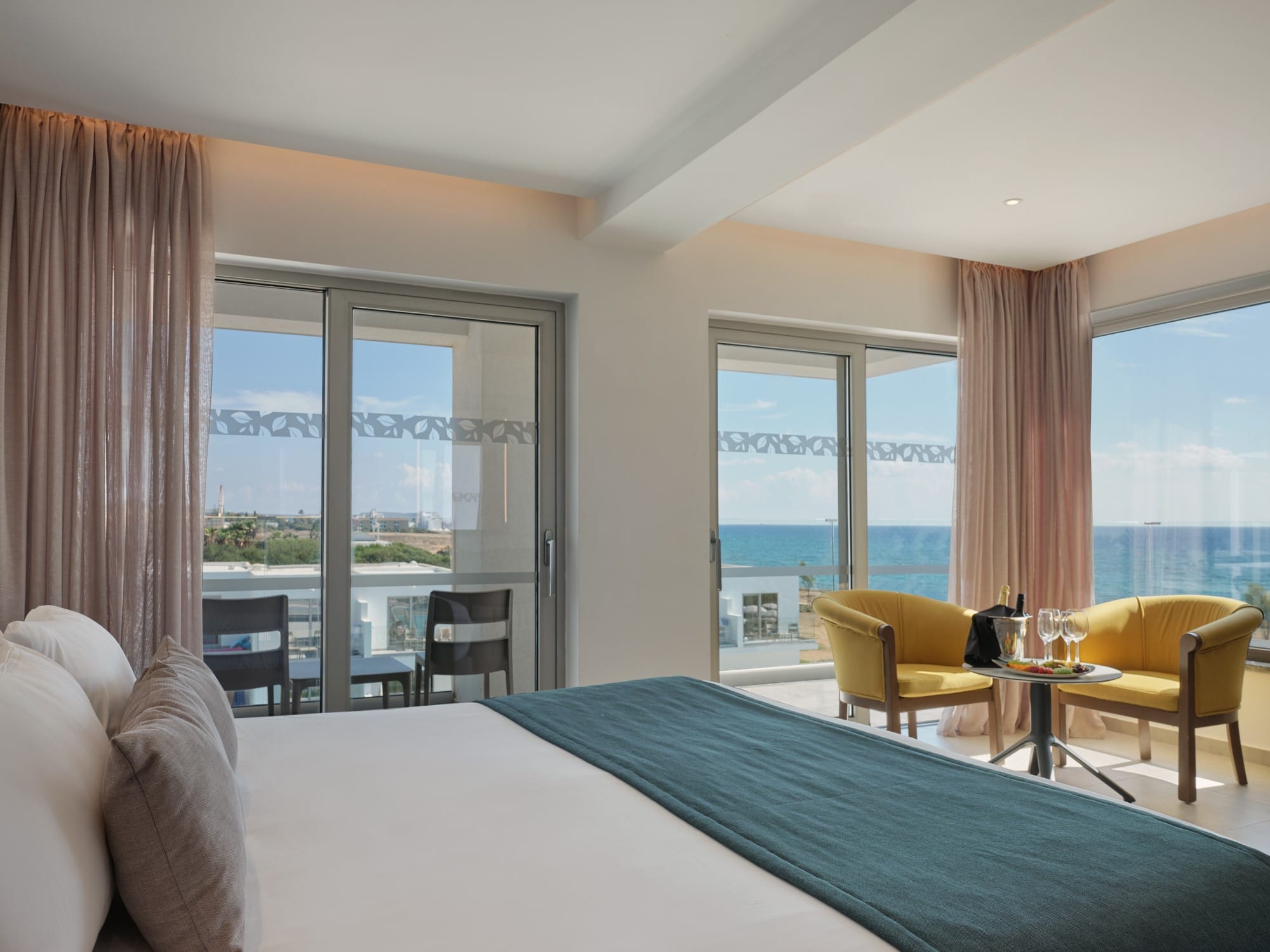 a bedroom with a view of the ocean