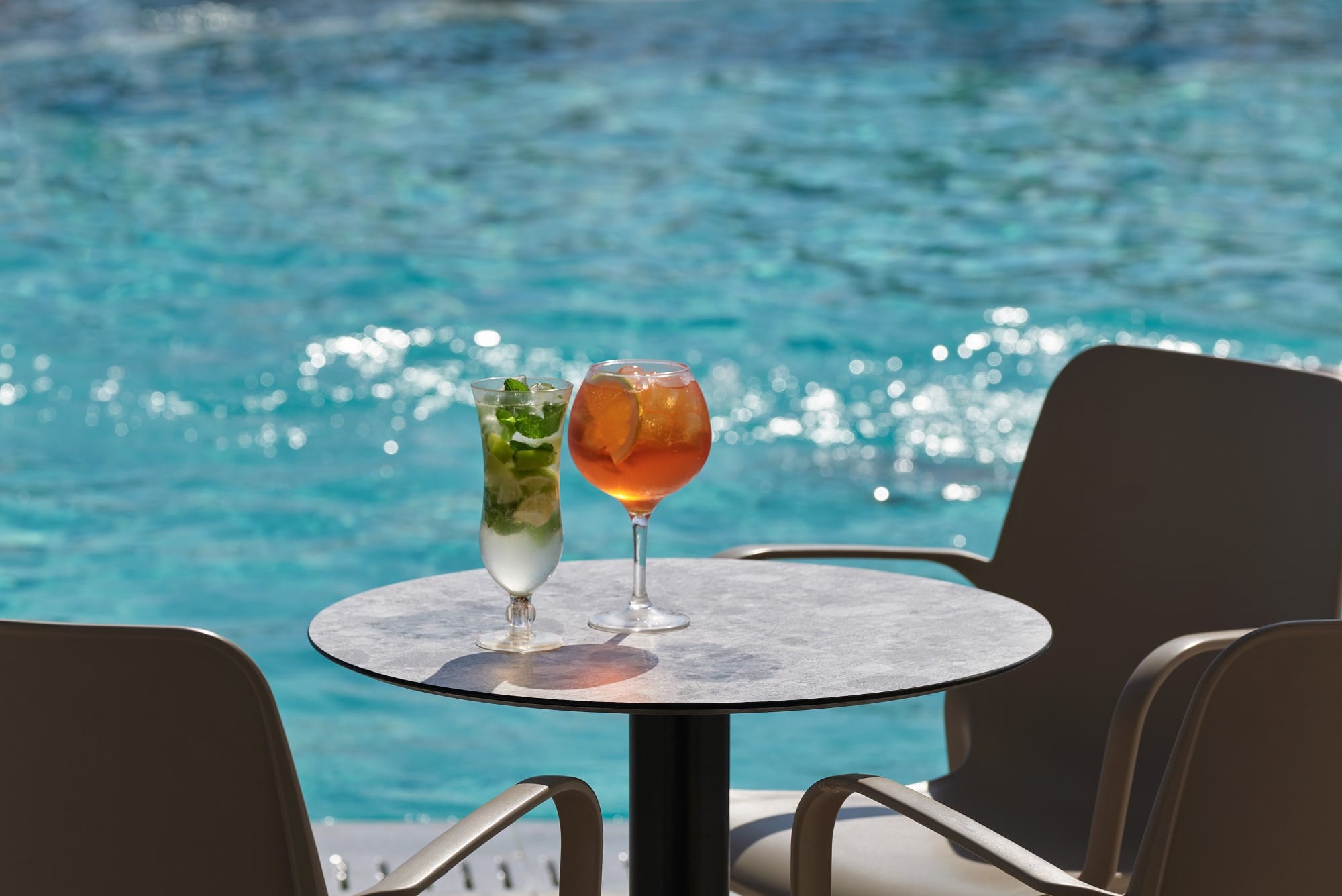 a table with drinks on it by a body of water