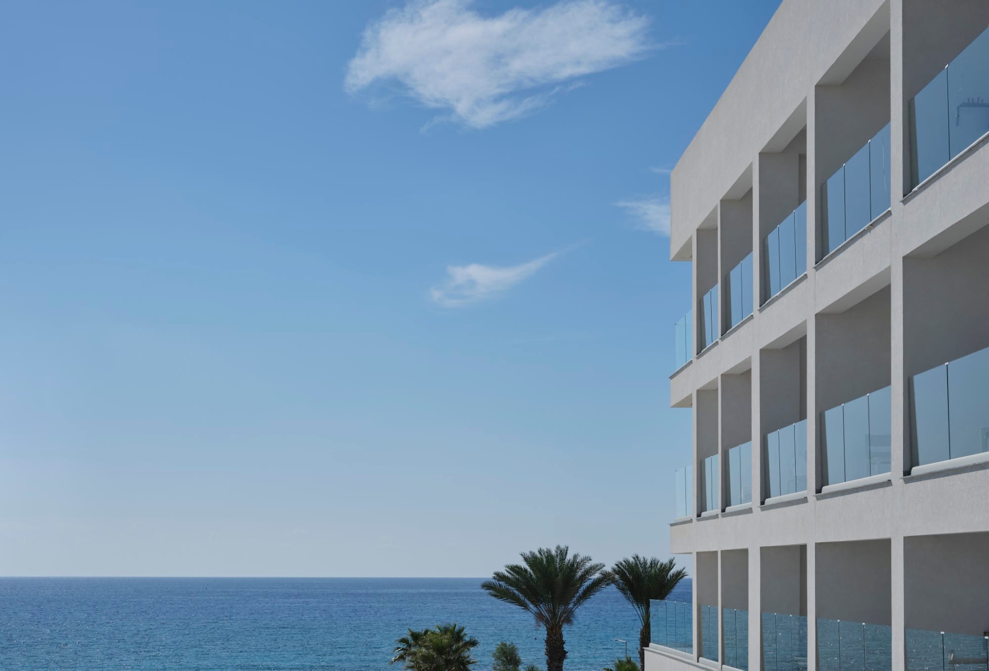 a building with a body of water in the background