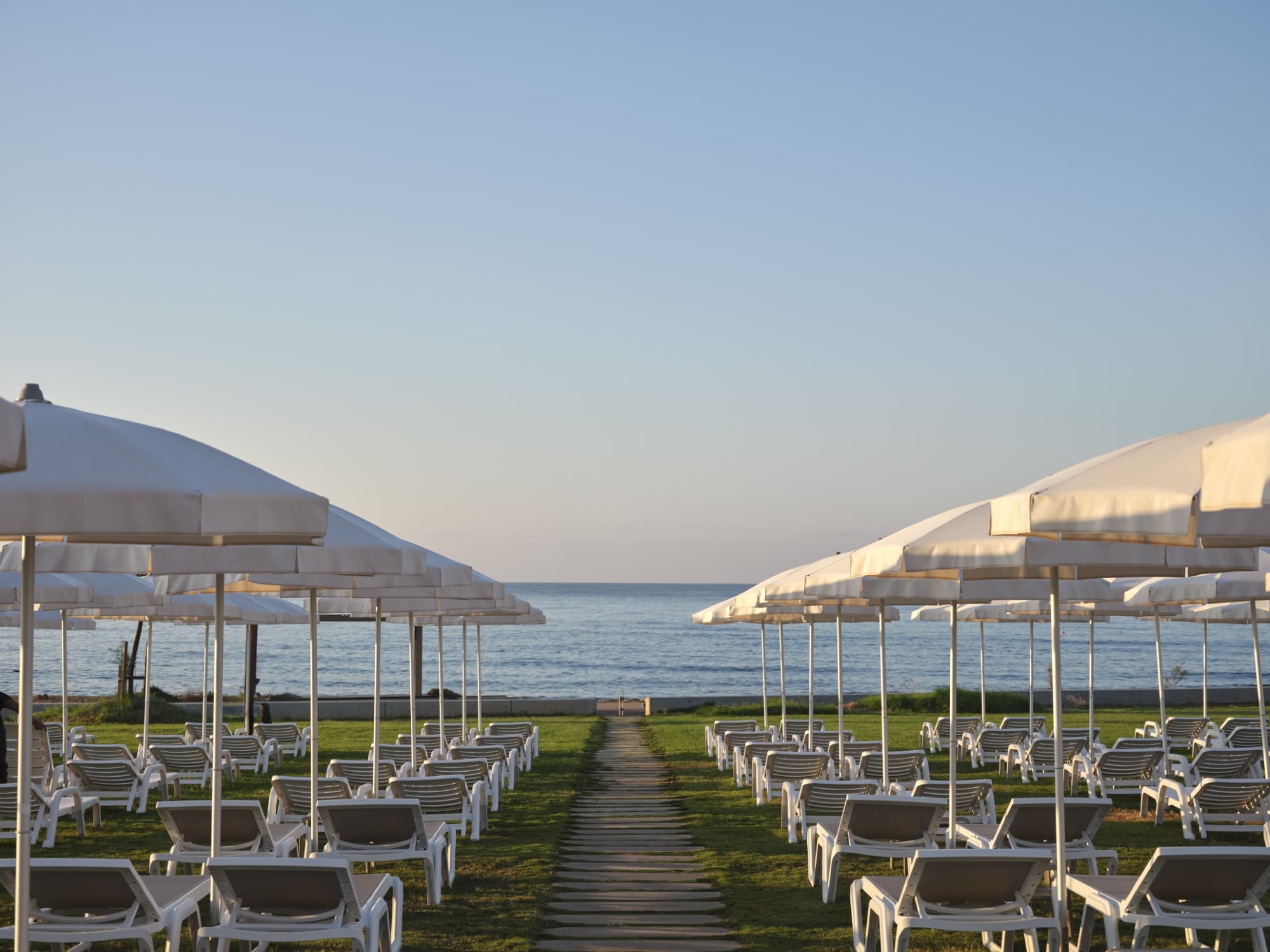 a boardwalk with umbrellas and chairs