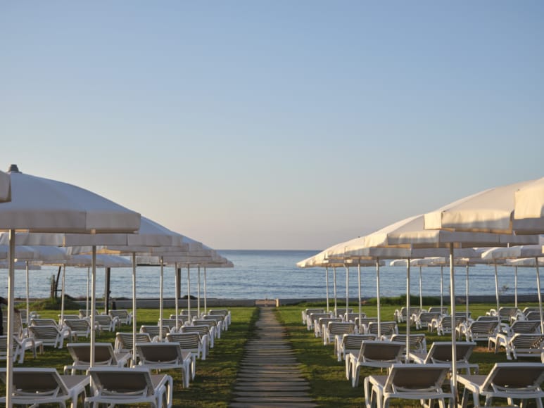 a boardwalk with umbrellas and chairs