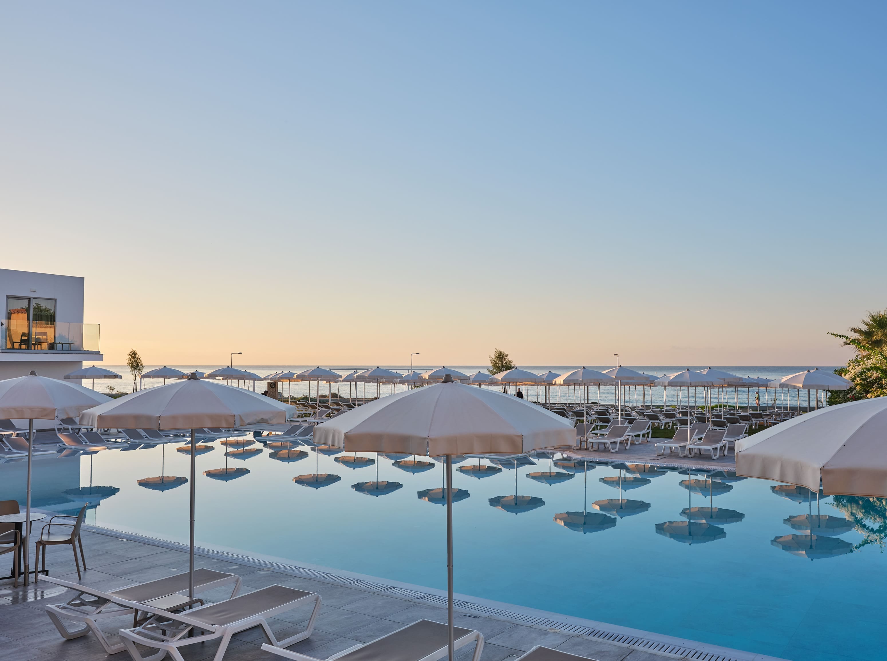a pool with umbrellas and chairs