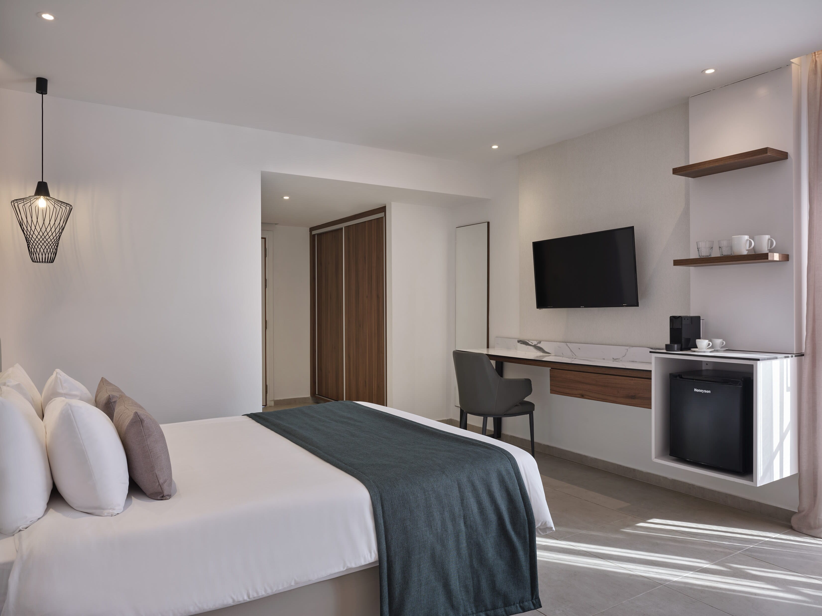 a bedroom with a bed and a tv