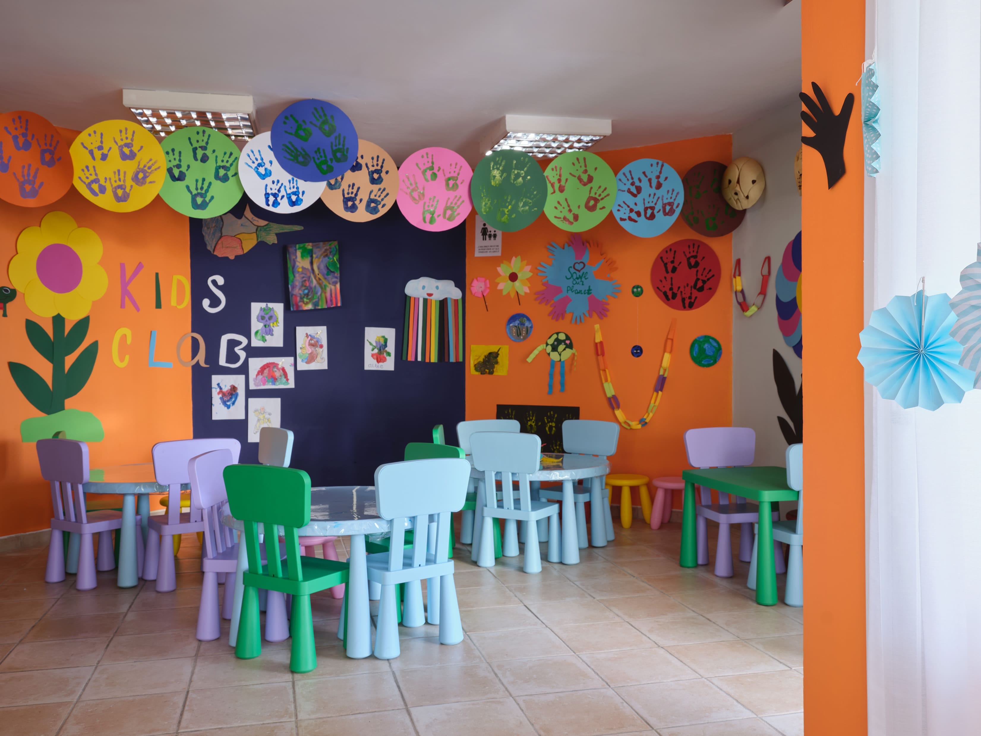 a room with colorful chairs and tables