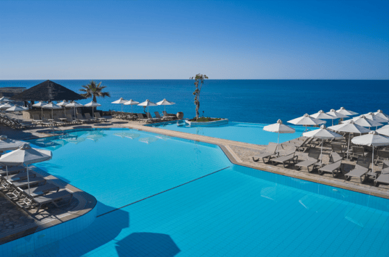 a pool with umbrellas and chairs by it