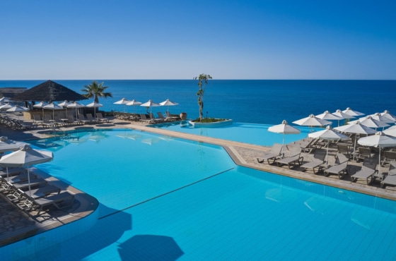 a pool with umbrellas and chairs by it
