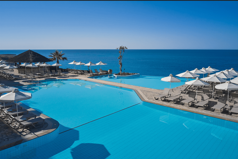 a pool with umbrellas and chairs by it