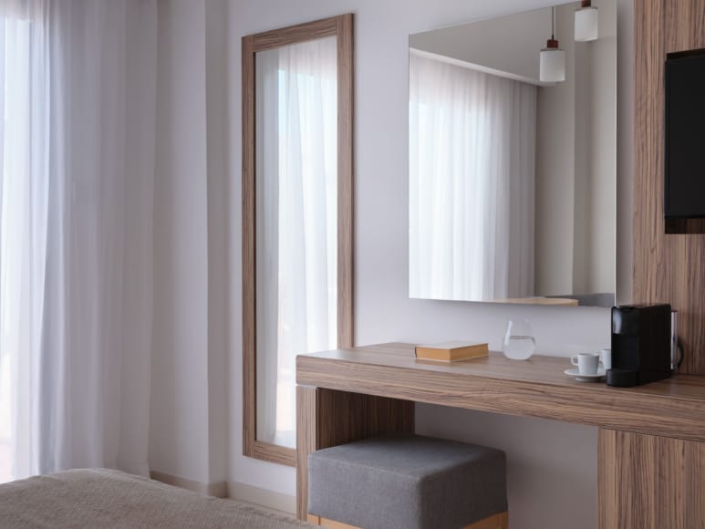 a desk with a computer and a window