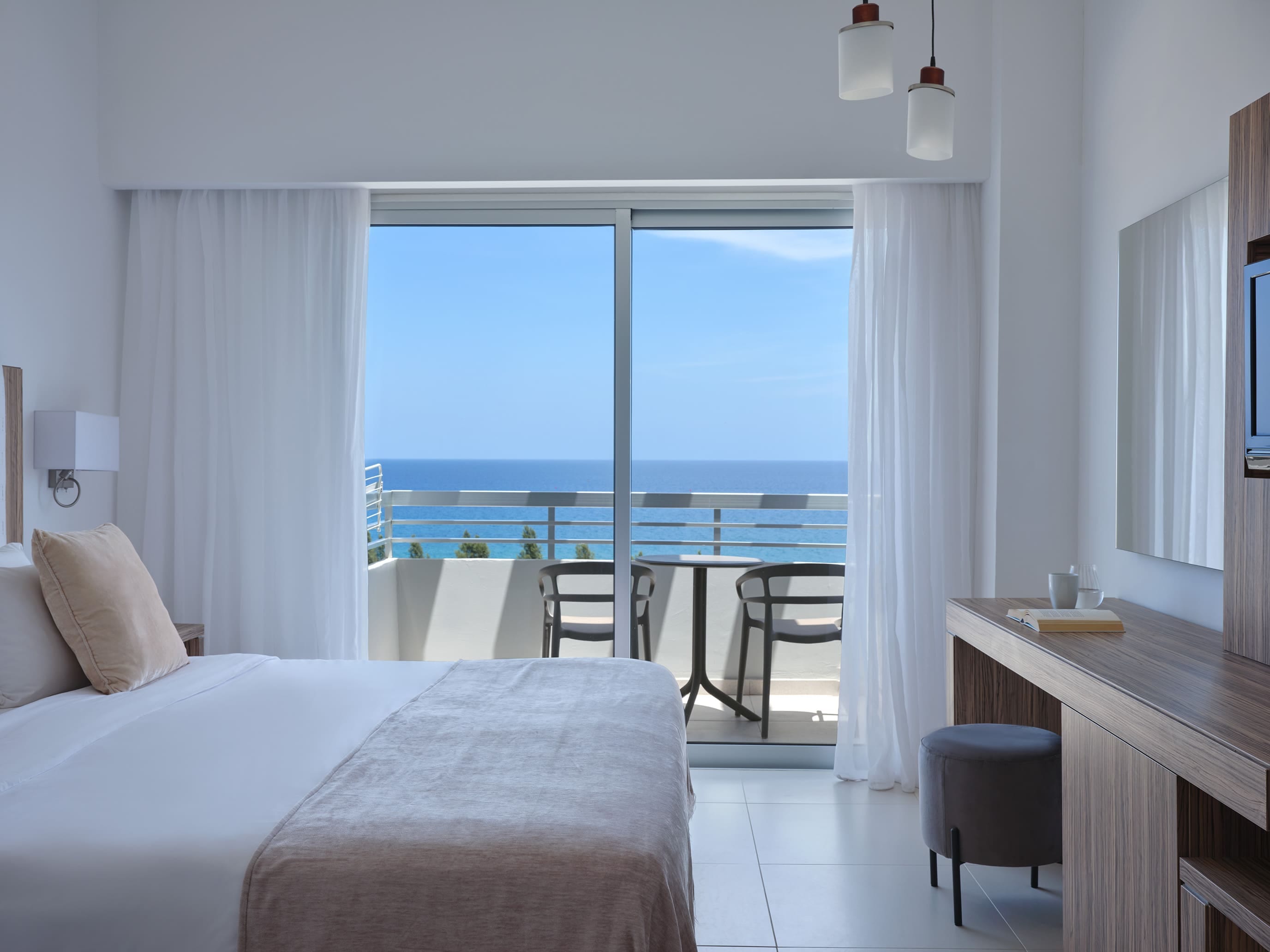 a bedroom with a view of the ocean