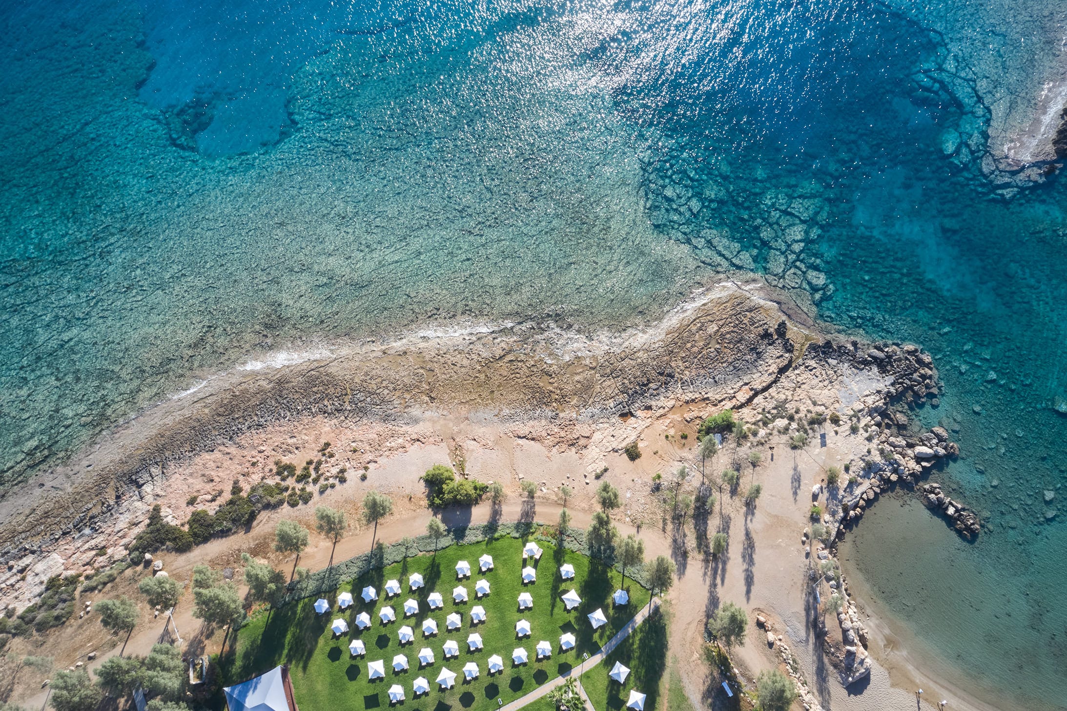 a large area with a body of water in the background