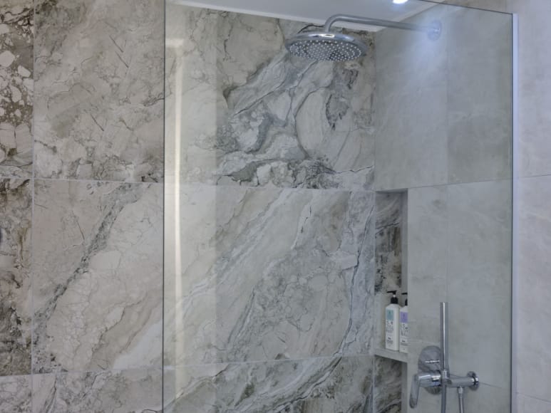 a shower with a stone wall