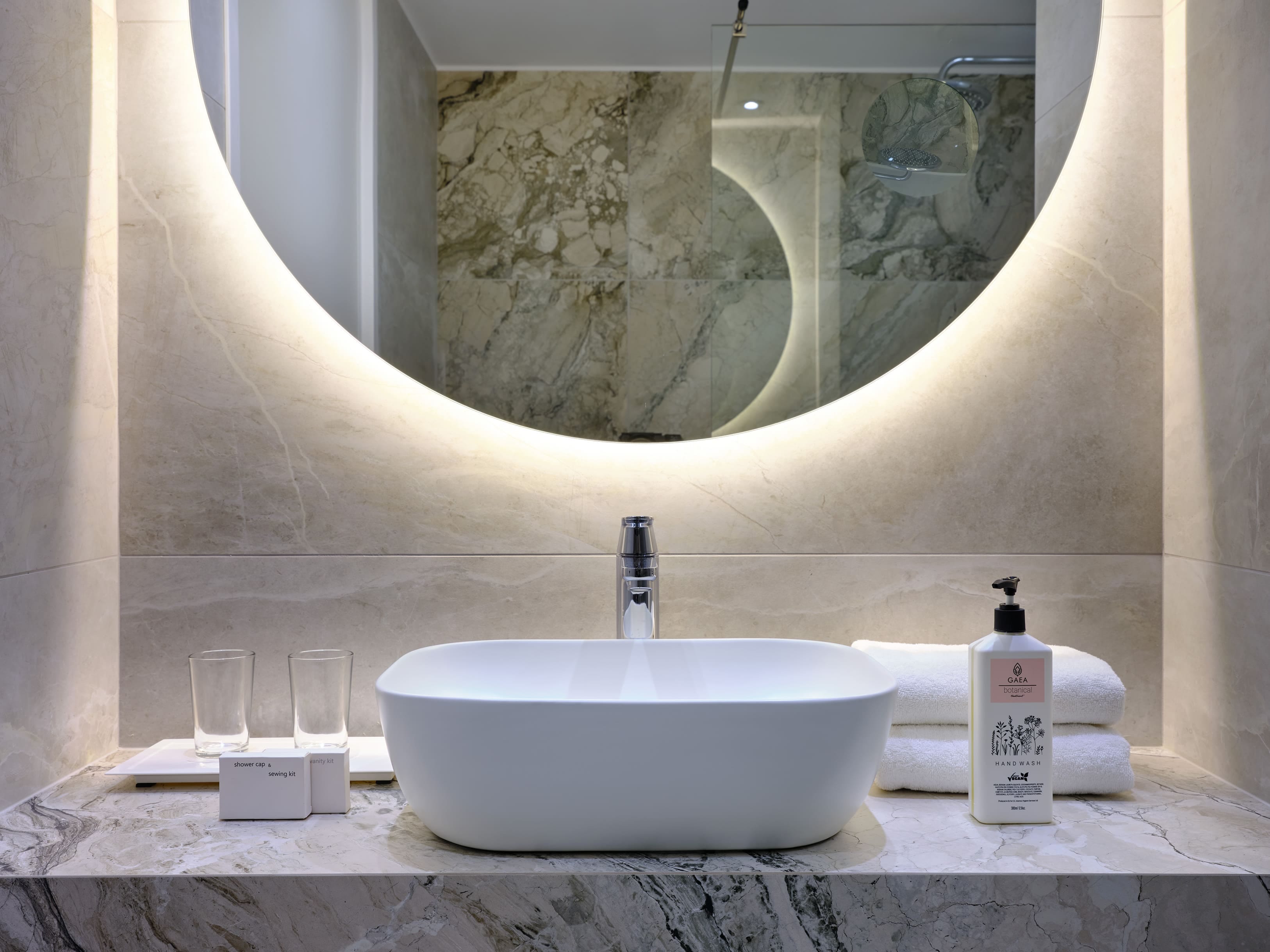 a bathroom sink with a large painting above it