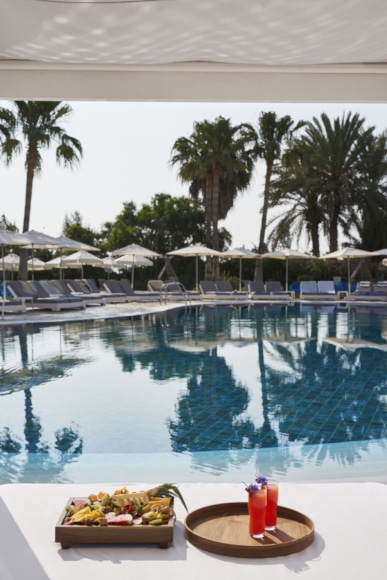 a pool with chairs and umbrellas