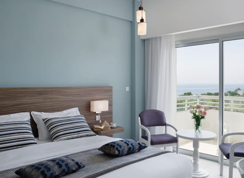 a bedroom with a bed and a chair