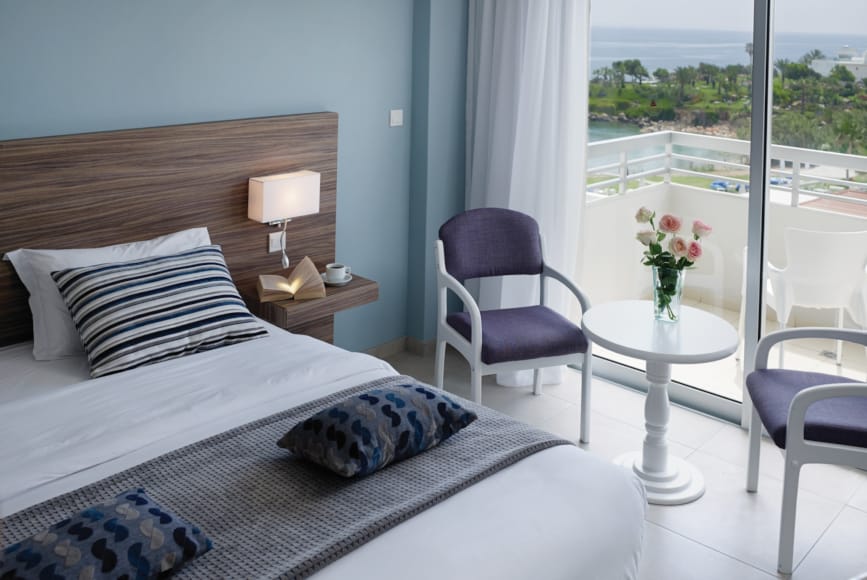 a bedroom with a bed and chairs